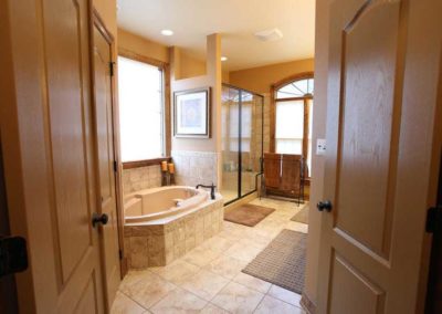 Bathroom with double doors and raised tub | Hauptman Builders