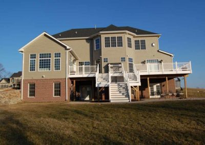 Exterior of custom home with raised deck by Hauptman Builders