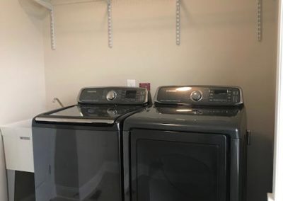Laundry room with separate washer and dryer units | Hauptman Builders