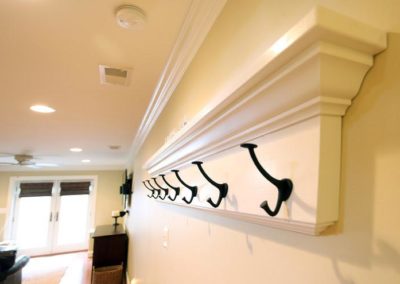 Coat rack hooks mounted on wall inside home | Hauptman Builders